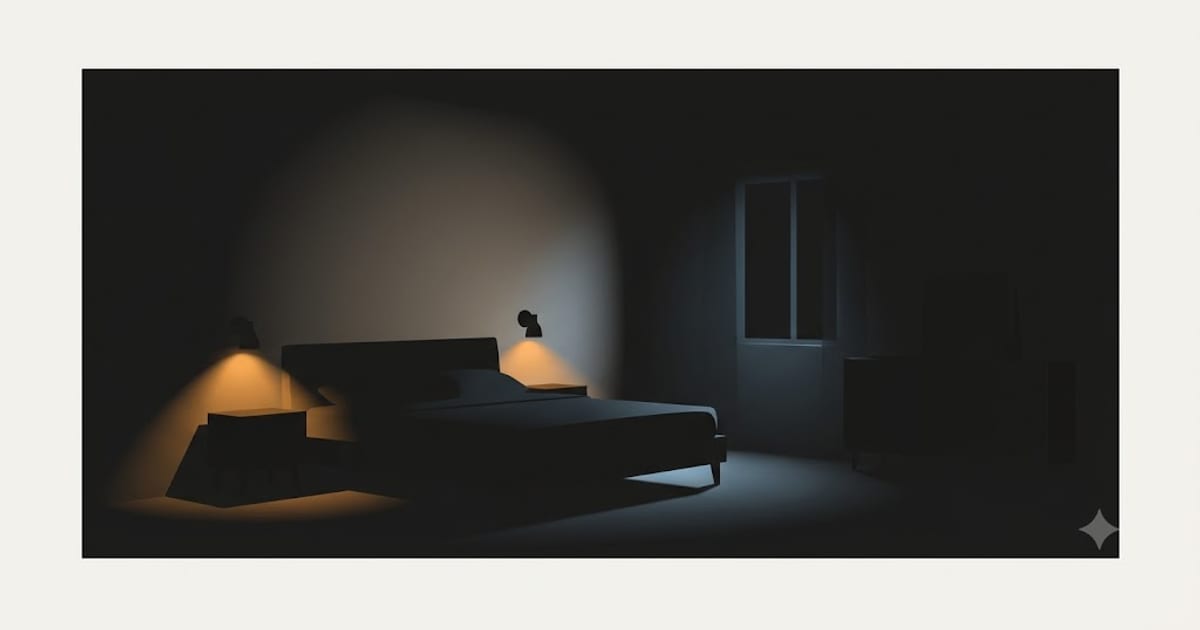 A bedroom lit only by two low bedside pools of light